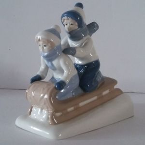 Children sledding porcelain figurine cuernavaca